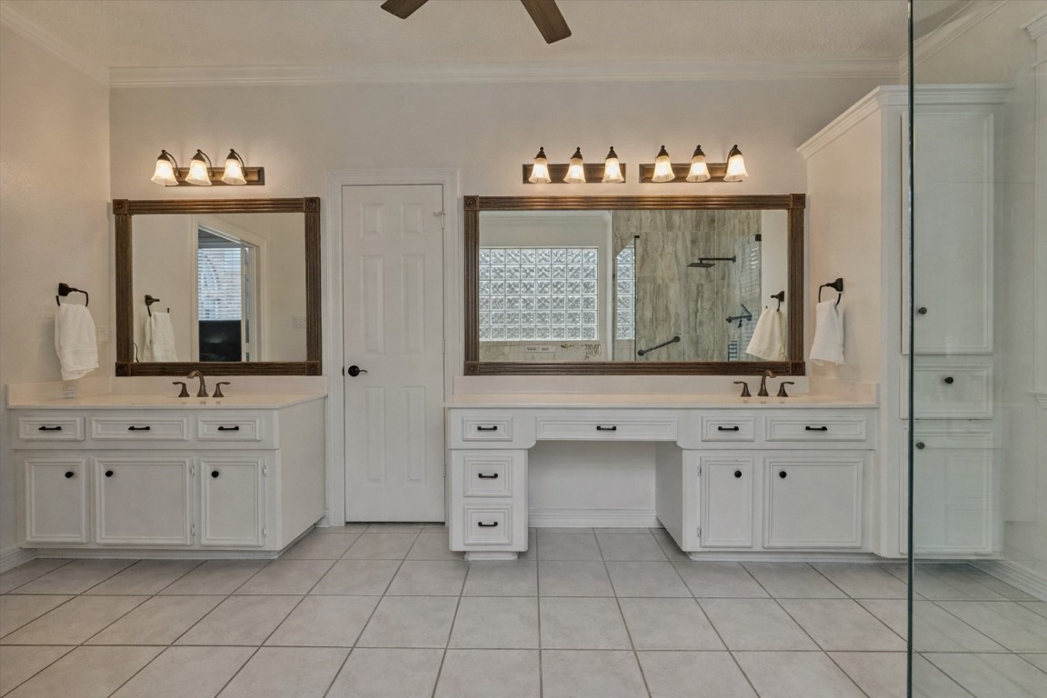 91 Wind Ridge Circle The Woodlands, TX 77381 - Photo 22 of 50 Dual sinks and a dedicated vanity space elevate this primary bathroom.