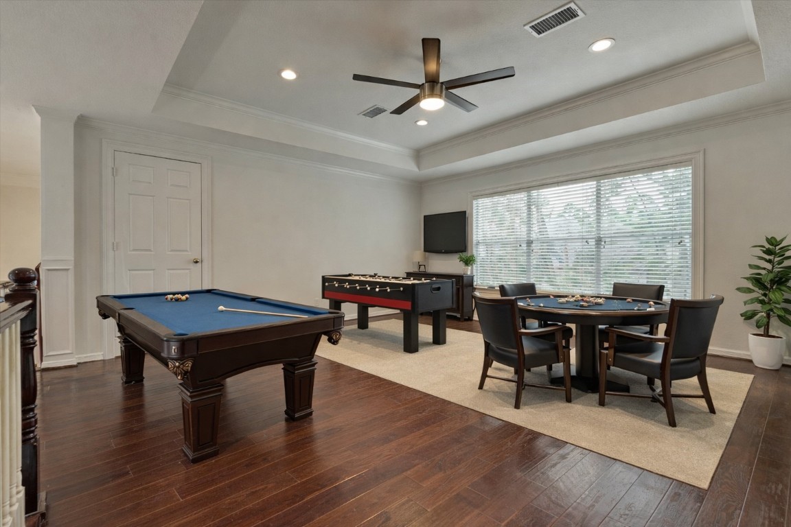 91 Wind Ridge Circle The Woodlands, TX 77381 - Photo 25 of 50 *This photo has been virtually staged* Expansive game room/living area upstairs with ceiling fan and trayed ceiling.