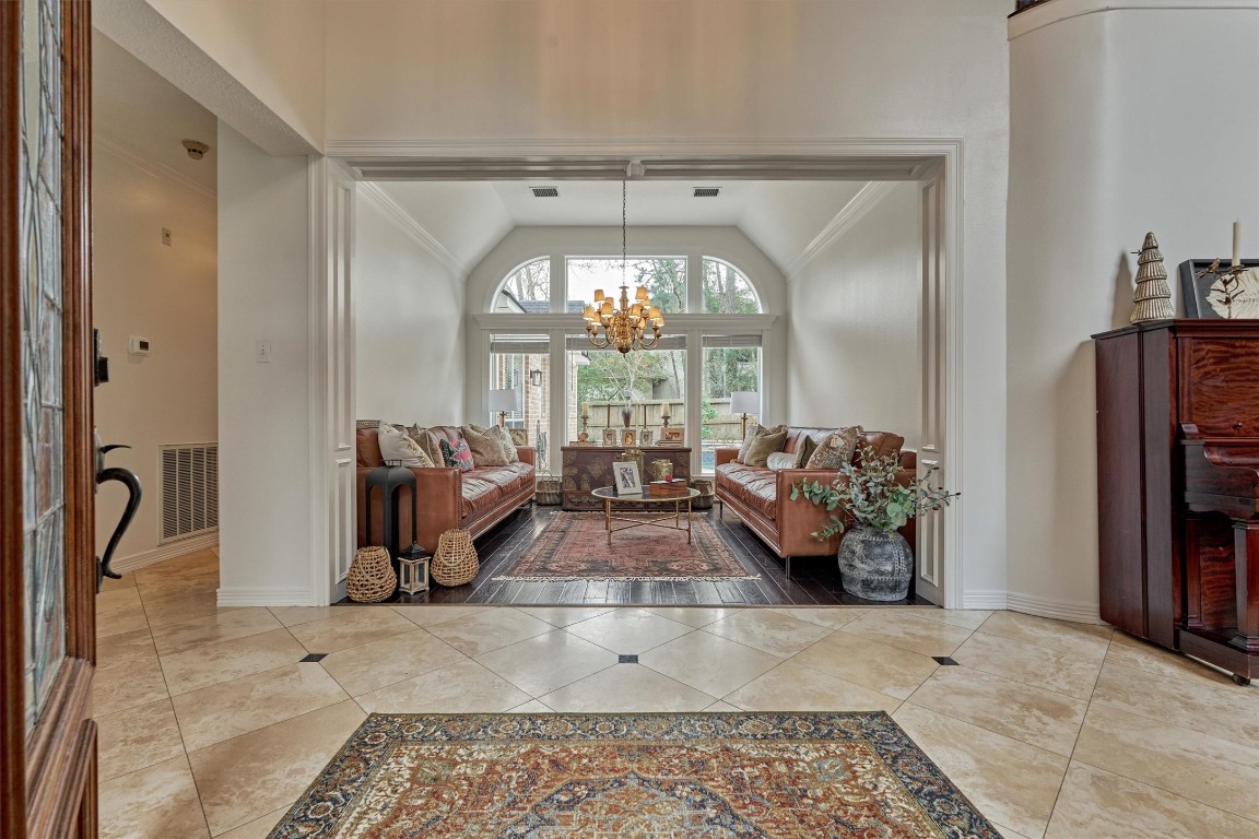91 Wind Ridge Circle The Woodlands, TX 77381 - Photo 4 of 50 Step inside to the grand two-story foyer with soaring ceilings and stunning sightlines into the private backyard oasis.