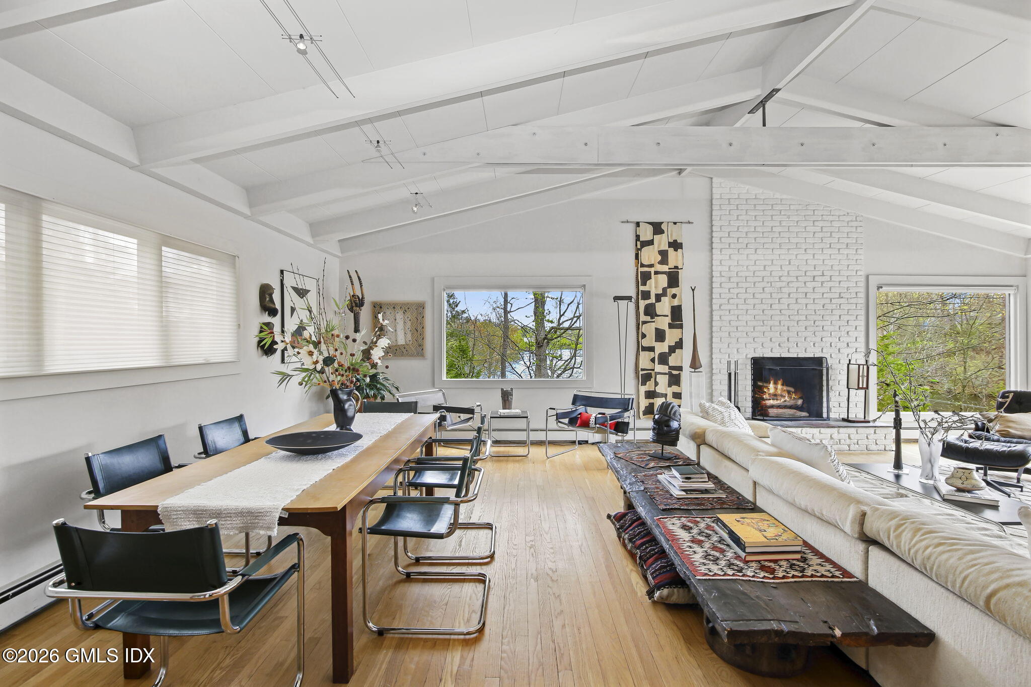185 Valley Road Cos Cob, CT 06807 - Photo 9 of 38 a living room with furniture a large window and a fireplace
