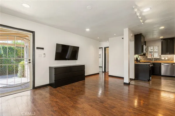 a view of a kitchen with a sink stainless steel appliances and cabinets