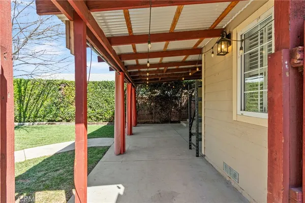 a front view of a house with a yard and potted plants