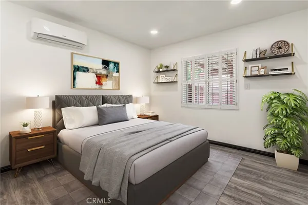 a bedroom with a bed and a painting on the wall