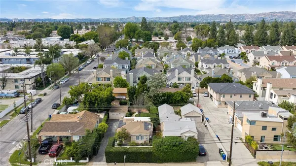 an aerial view of multiple houses with yard