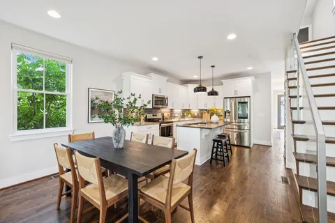 a dining room with furniture and wooden floor