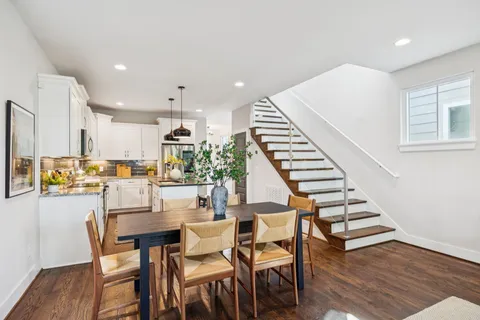 a dining room with furniture and wooden floor