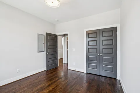 a bathroom with a granite countertop sink a toilet and shower