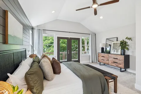 a bedroom with a bed and a chandelier