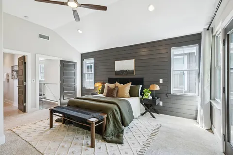 a bedroom with furniture and a flat tv screen