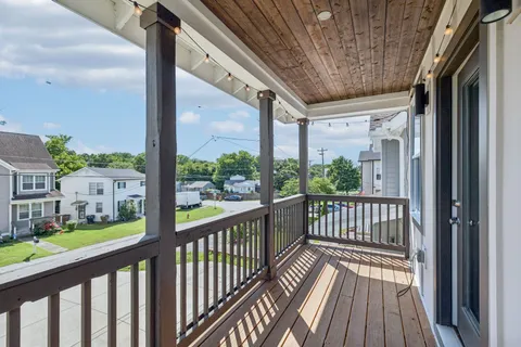 a view of a room with a door and a rug