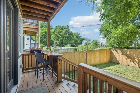 a front view of a house with a yard and potted plants