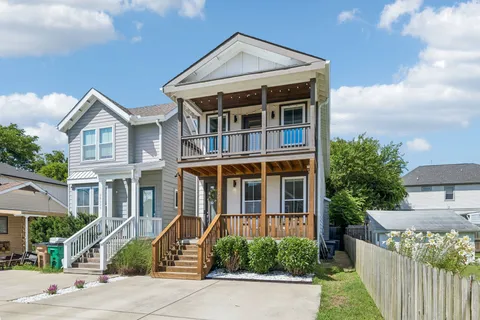 an aerial view of a house with garden space and street view