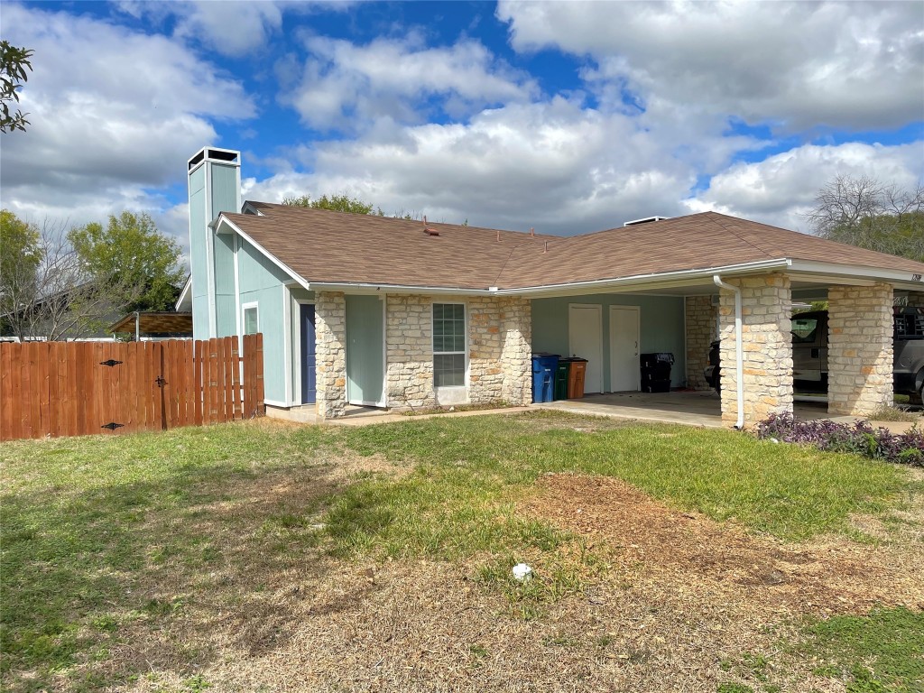 12810 Broughton Way, Unit A Austin, TX 78727 - Photo 11 of 16 a front view of a house with a yard and garage
