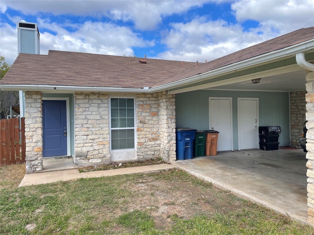 12810 Broughton Way, Unit A Austin, TX 78727 - Photo 12 of 16 a view of a house with a yard and garage