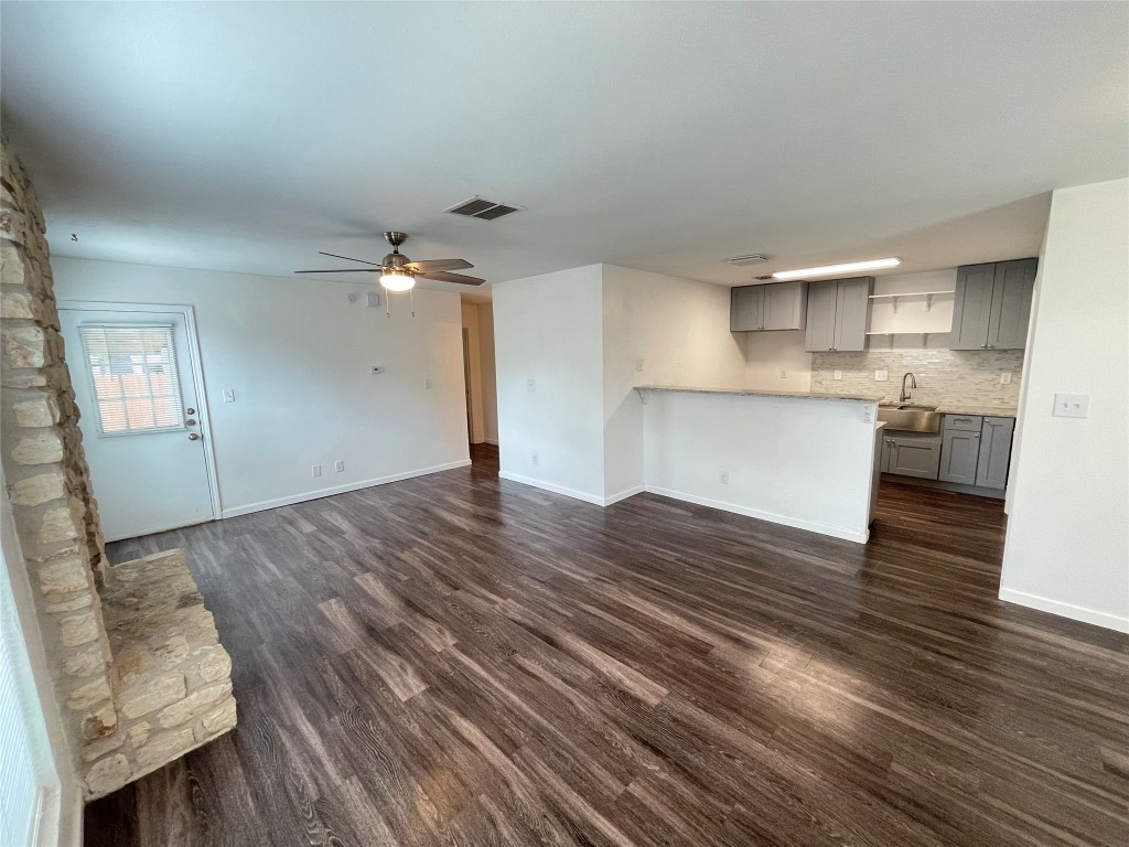 12810 Broughton Way, Unit A Austin, TX 78727 - Photo 4 of 16 a view of kitchen and empty room with wooden floor