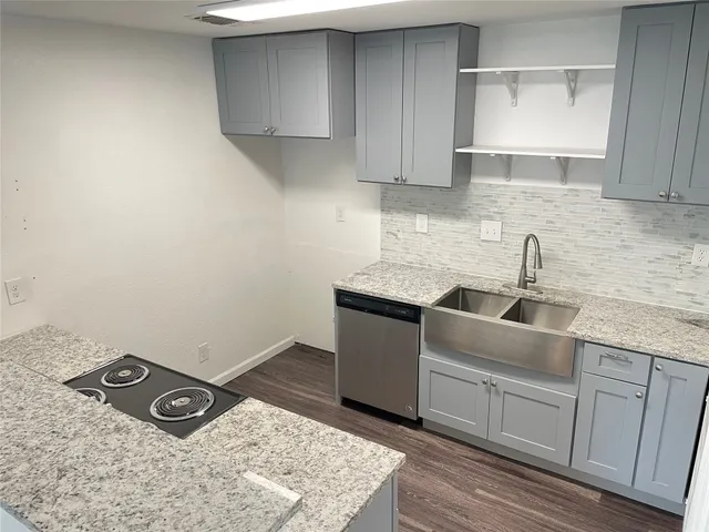 a kitchen with a sink and cabinets