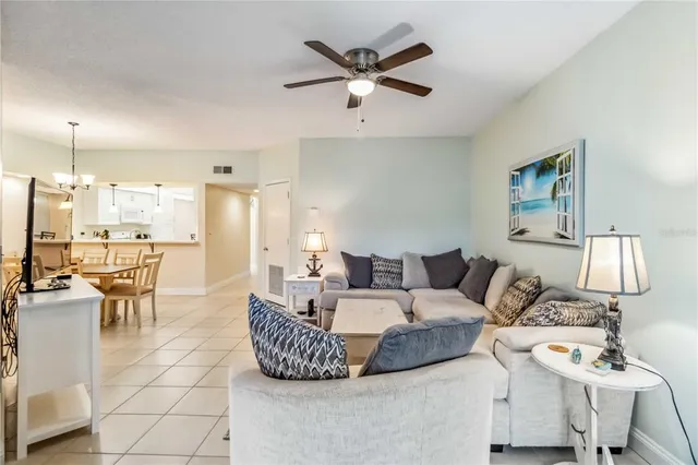 a living room with furniture and kitchen view