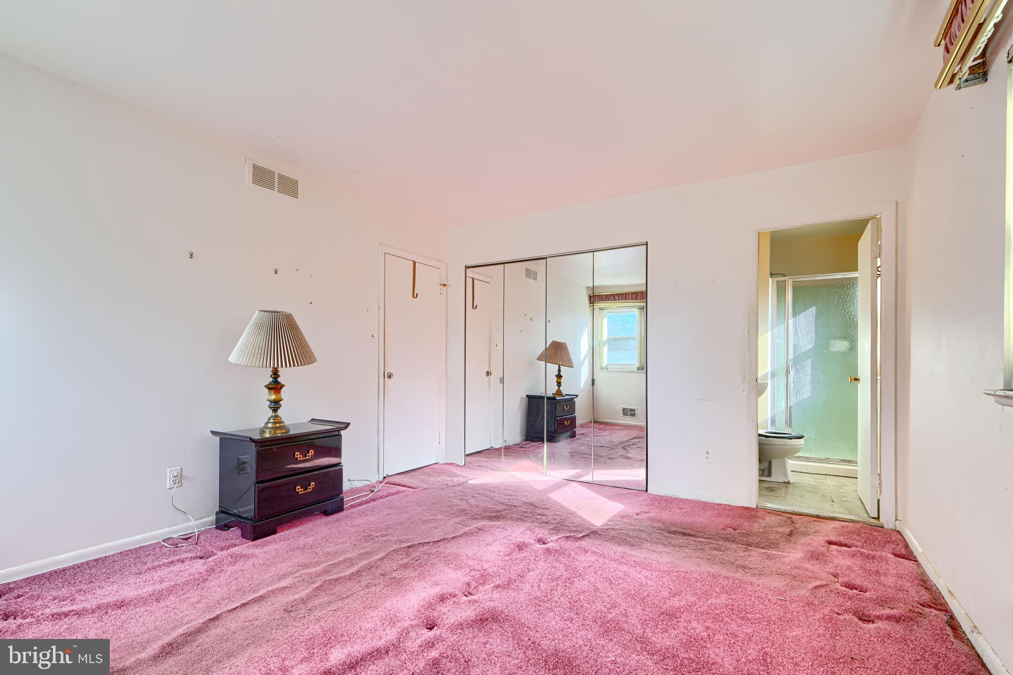 7209 Pinecrest Road Baltimore, MD 21228 - Photo 12 of 35 a spacious bedroom with a bed and a view of bathroom