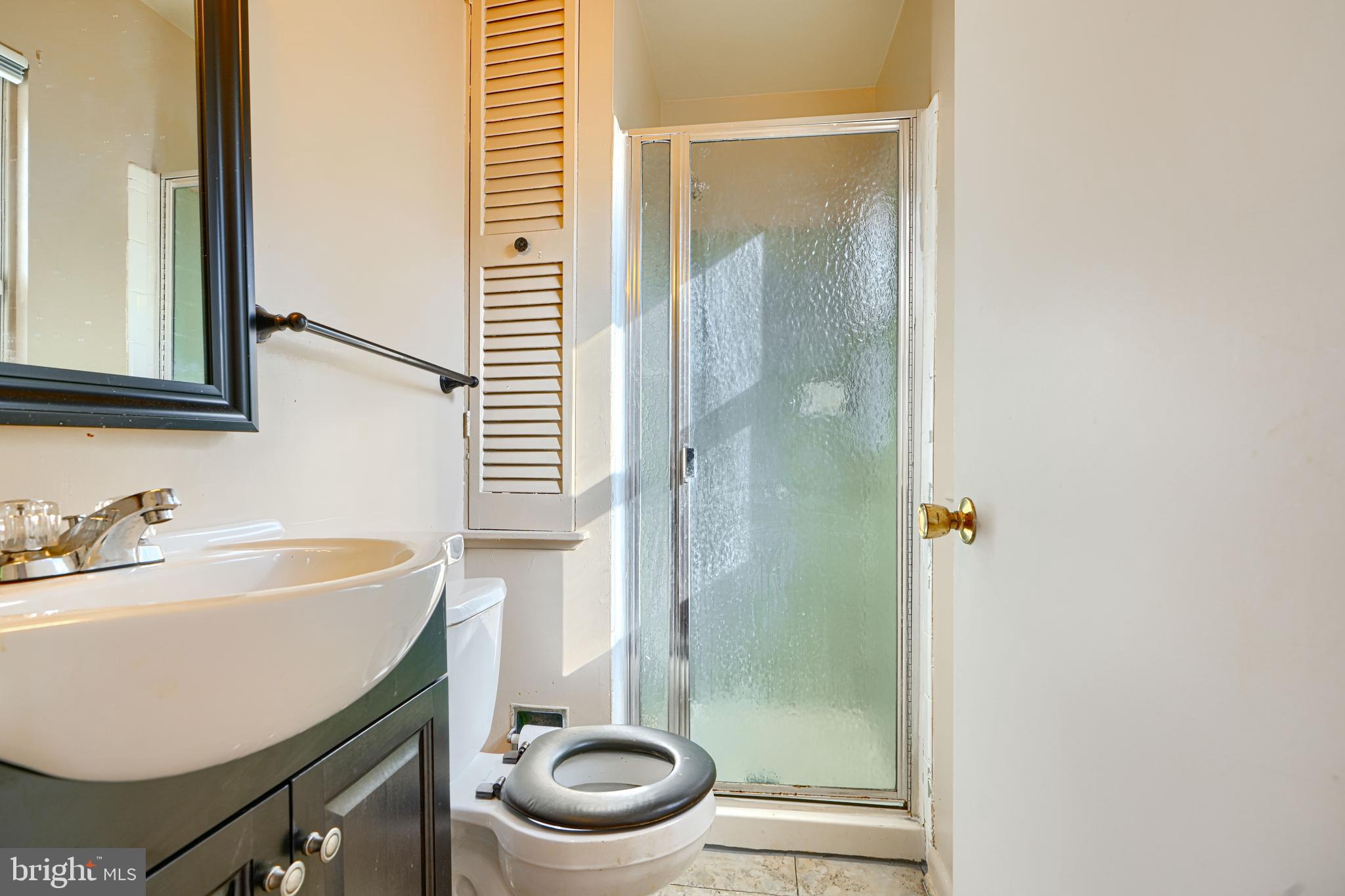 7209 Pinecrest Road Baltimore, MD 21228 - Photo 13 of 35 a bathroom with a sink a toilet and shower