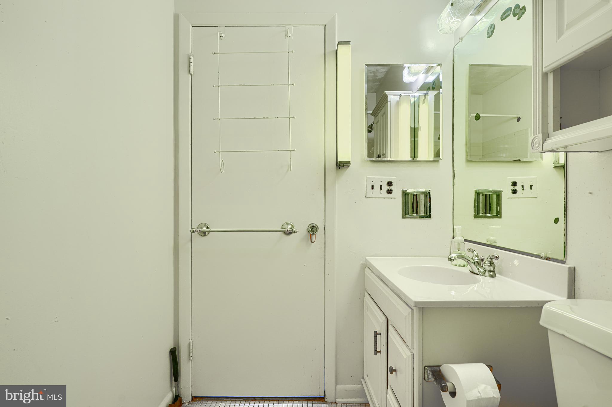 7209 Pinecrest Road Baltimore, MD 21228 - Photo 15 of 35 a bathroom with a double vanity sink and mirror