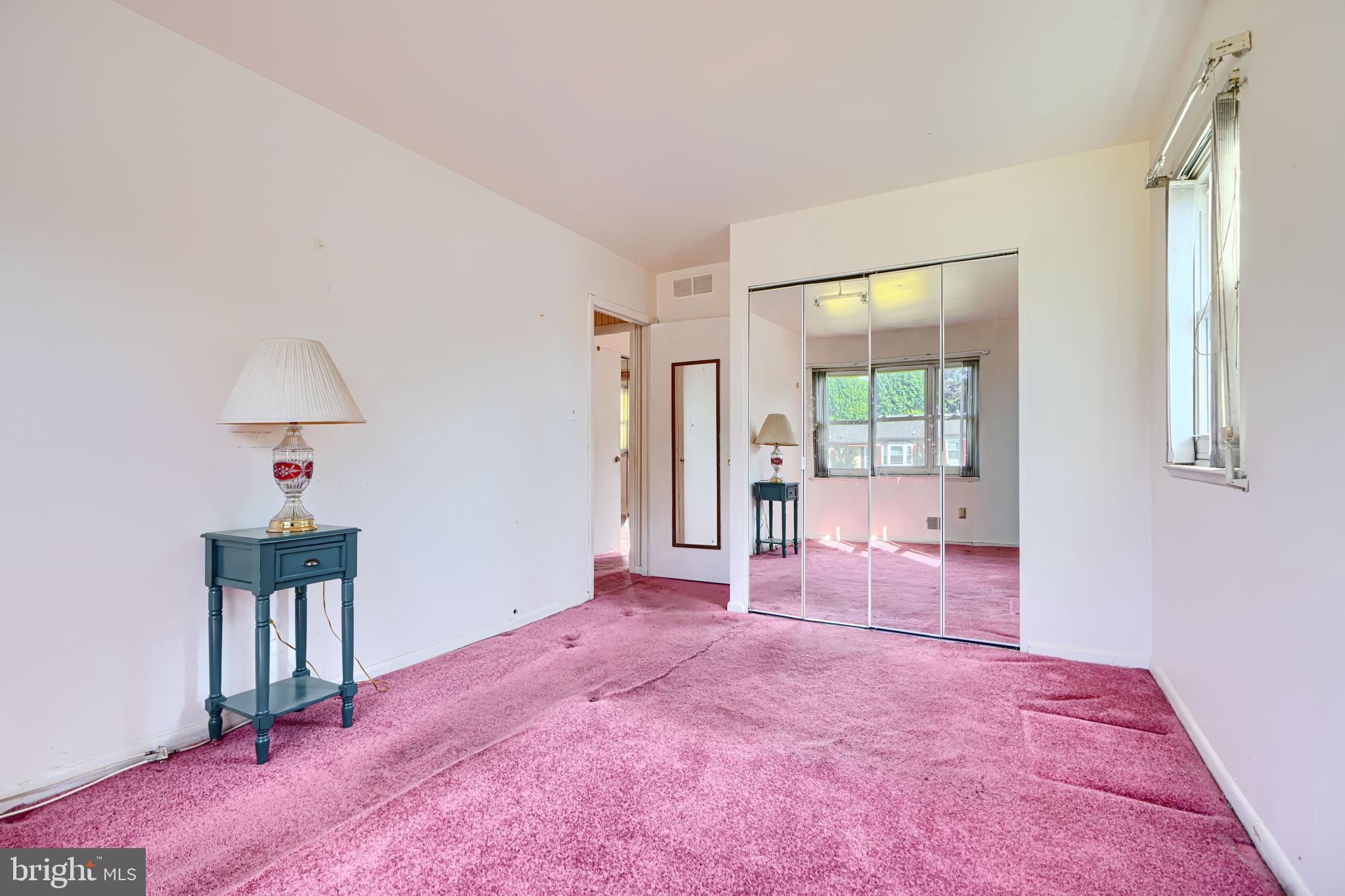 7209 Pinecrest Road Baltimore, MD 21228 - Photo 18 of 35 a spacious bedroom with a bed and a table in it