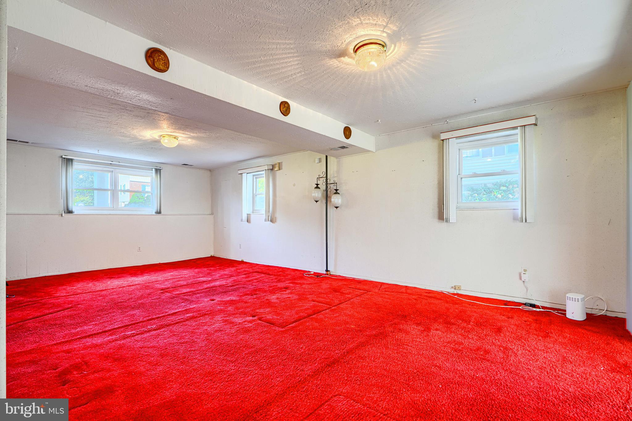 7209 Pinecrest Road Baltimore, MD 21228 - Photo 26 of 35 a bedroom with a large bed and a chandelier