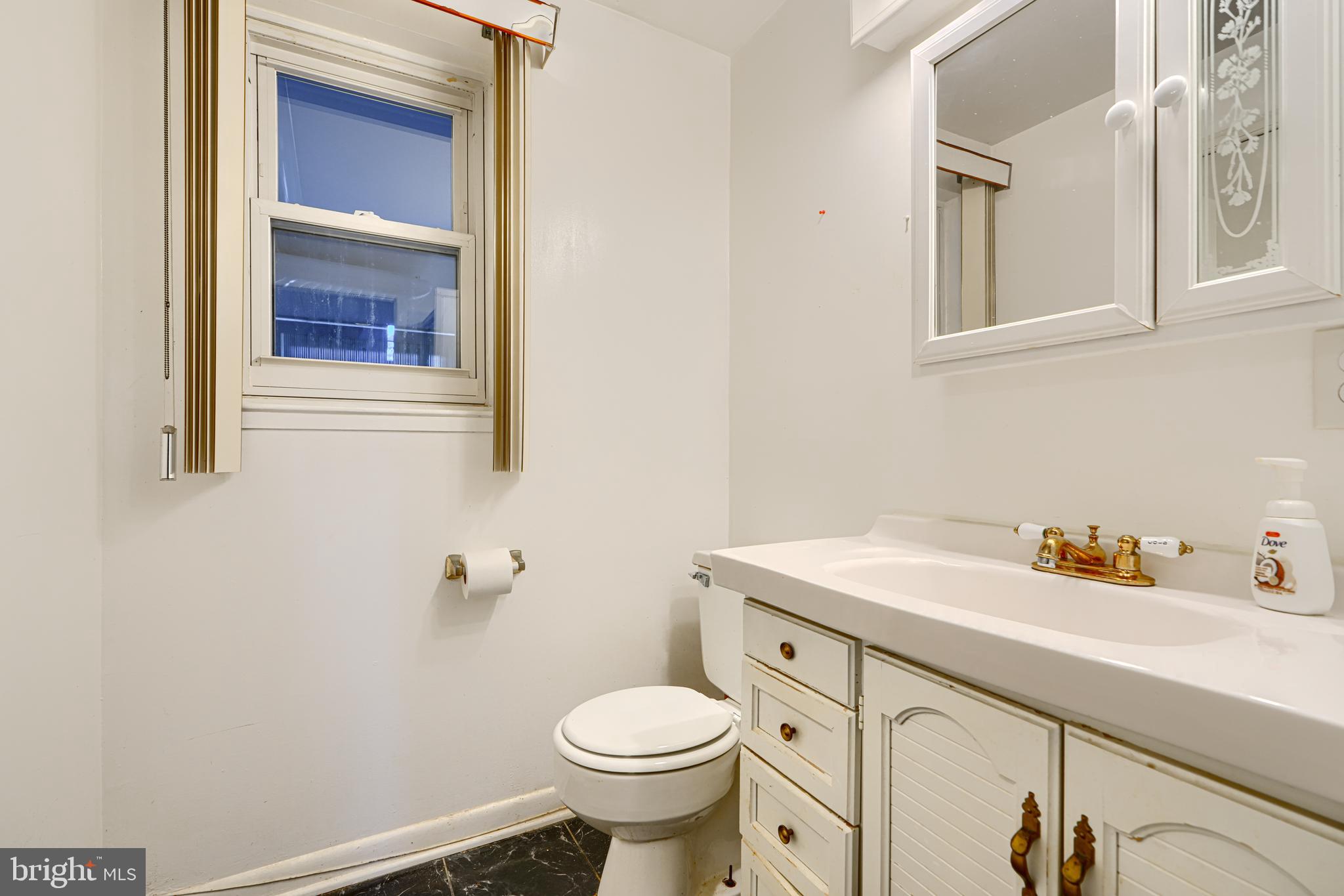 7209 Pinecrest Road Baltimore, MD 21228 - Photo 29 of 35 a bathroom with a sink and a toilet