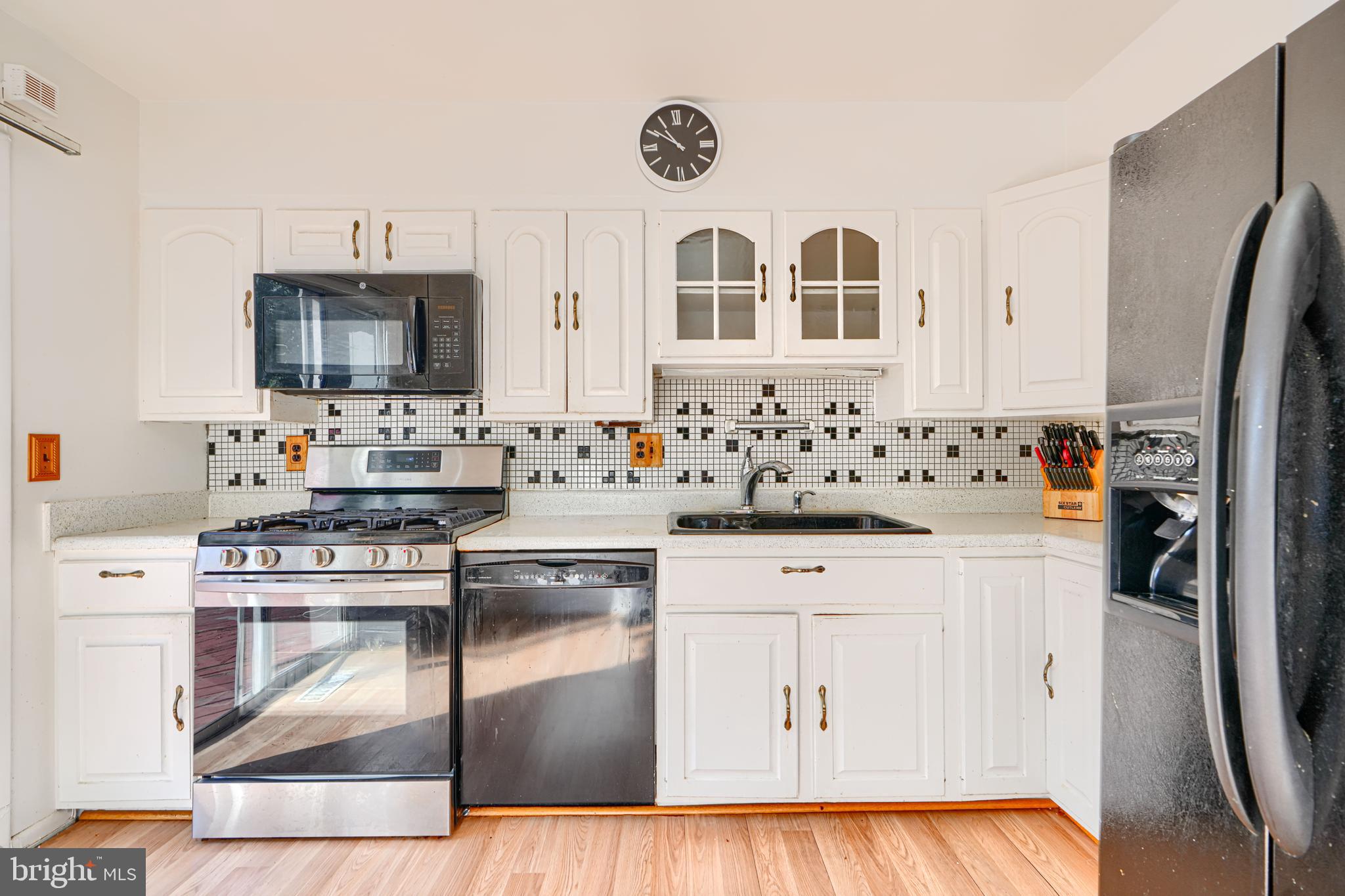 7209 Pinecrest Road Baltimore, MD 21228 - Photo 10 of 35 a kitchen with stainless steel appliances granite countertop a stove and a refrigerator
