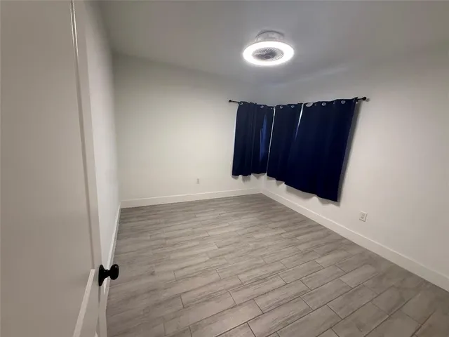 an empty room with wooden floor