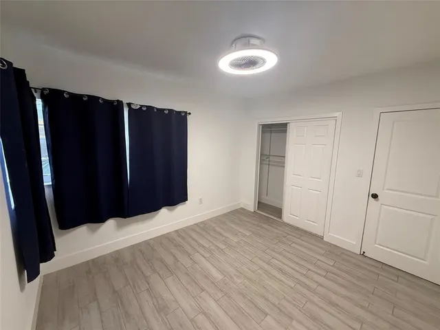 a view of closet with wooden floor