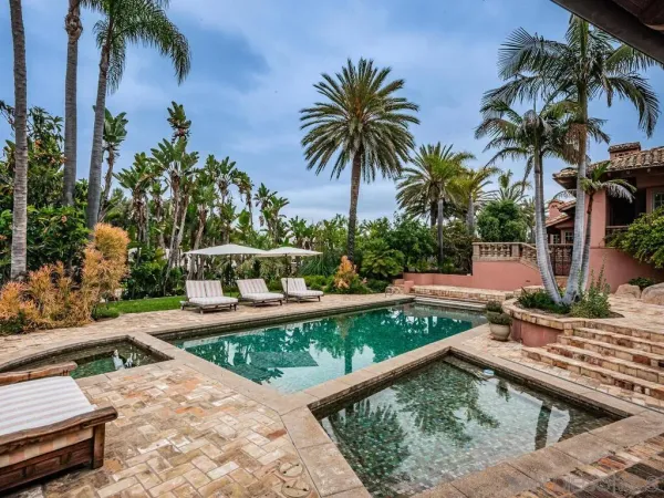 a view of swimming pool with a patio and a garden