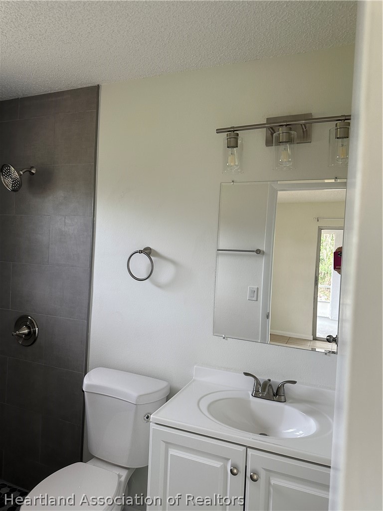 237 Rhapsody Avenue Lake Placid, FL 33852 - Photo 11 of 18 a bathroom with a sink toilet and a mirror