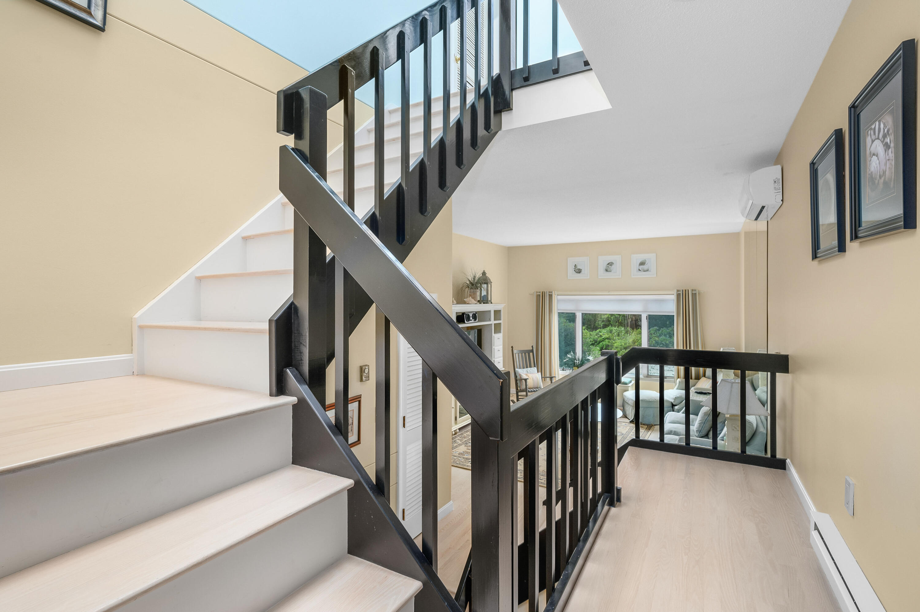 500 Ocean Street, Unit 68 Hyannis, MA 02601 - Photo 14 of 39 a view of staircase with lots of frames on wall and wooden floor