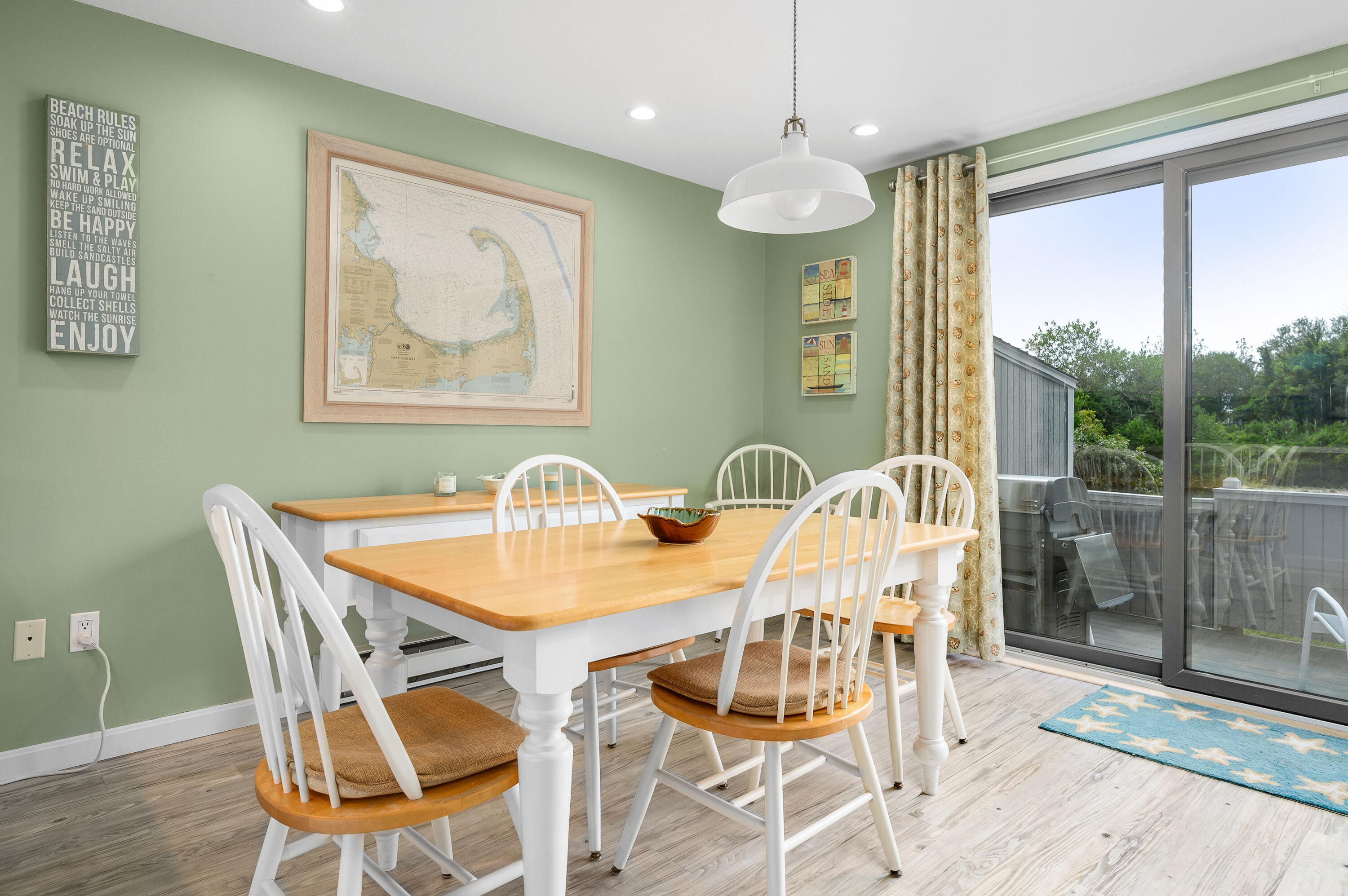 500 Ocean Street, Unit 68 Hyannis, MA 02601 - Photo 5 of 39 a view of a dining room with furniture wooden floor and a chandelier