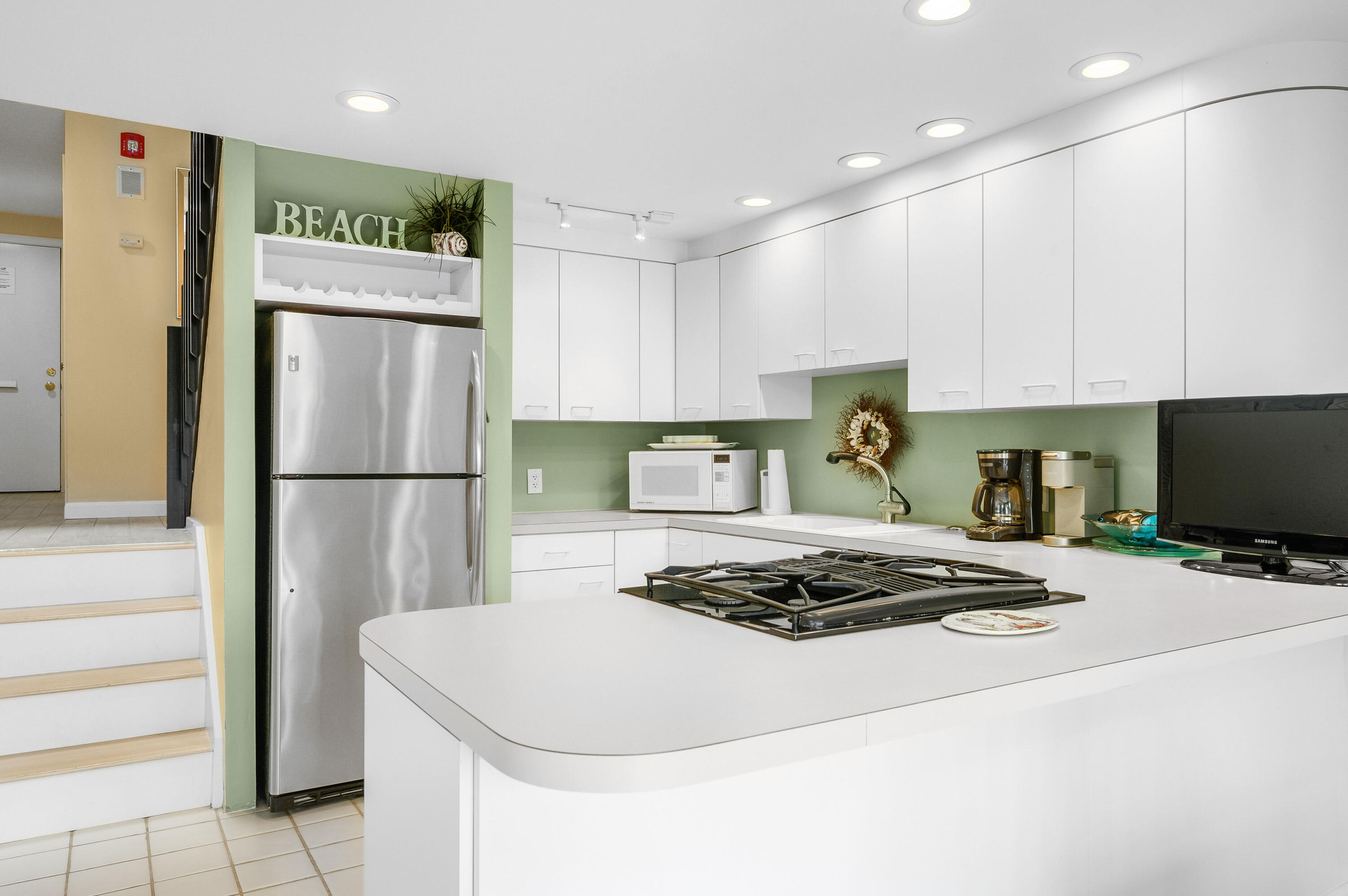 500 Ocean Street, Unit 68 Hyannis, MA 02601 - Photo 9 of 39 a kitchen with a refrigerator a stove a sink and white cabinets
