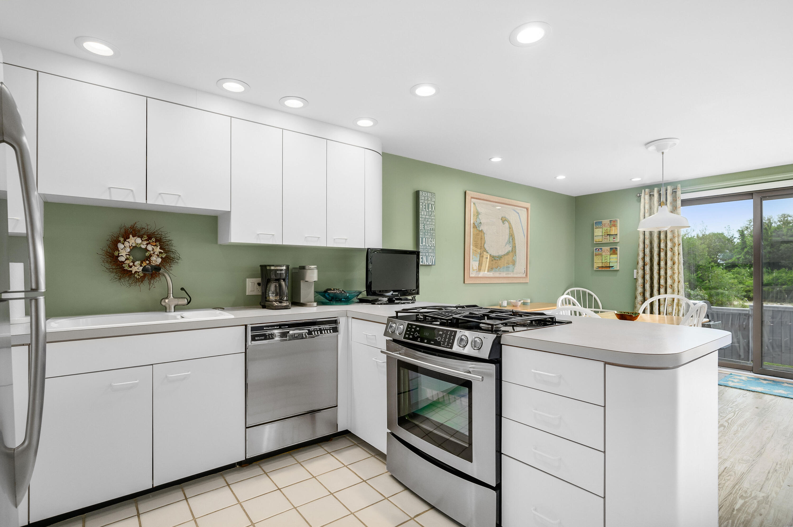 500 Ocean Street, Unit 68 Hyannis, MA 02601 - Photo 10 of 39 a kitchen with a sink stove and cabinets