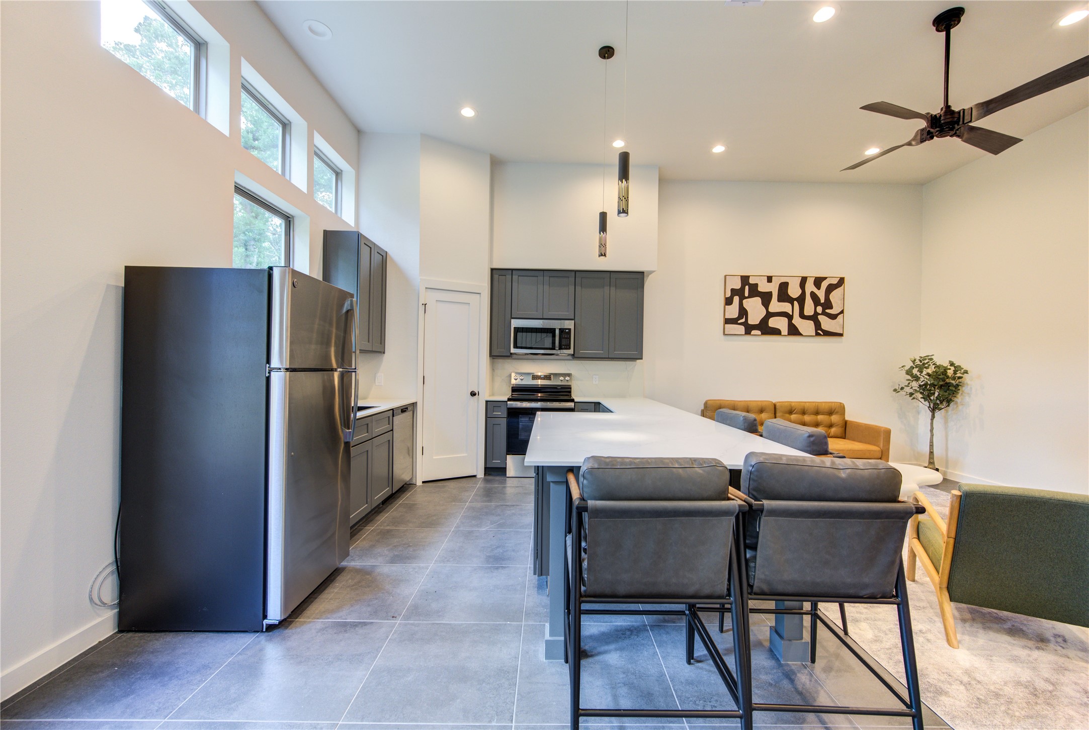 13115 Wild Orchid Lane Cypress, TX 77429 - Photo 10 of 48 a kitchen with a refrigerator a dining table and chairs