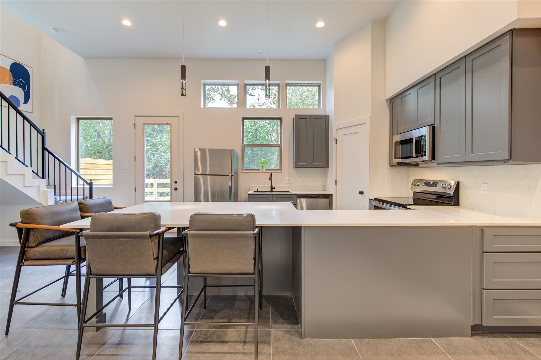 13115 Wild Orchid Lane Cypress, TX 77429 - Photo 12 of 48 a kitchen with stainless steel appliances granite countertop a sink a stove a microwave a dining table and chairs