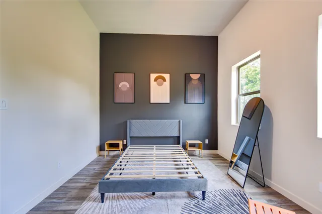 a bedroom with furniture and a window