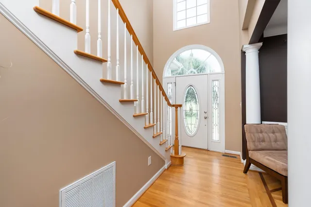 a view of entryway and hall with wooden floor