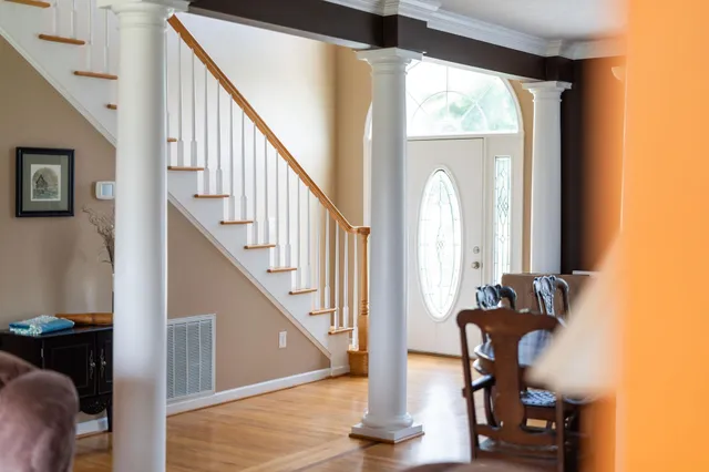 a view of entryway and hall with wooden floor