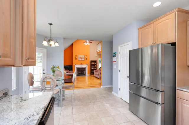a kitchen with stainless steel appliances granite countertop a refrigerator and a sink