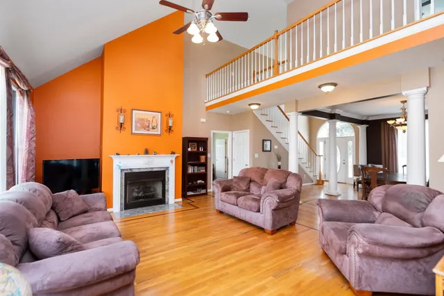 a living room with furniture flat screen tv and a fireplace