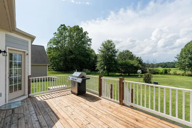 a view of a deck with chair and wooden floor