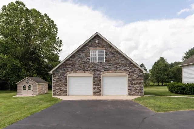 a front view of a house with a garden and yard