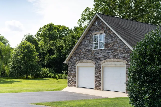 a front view of a house with a garden and yard