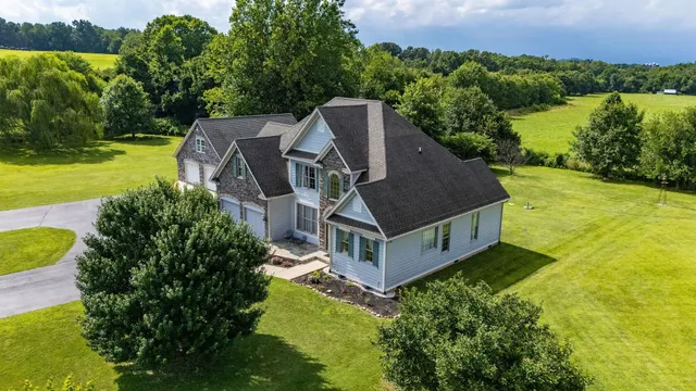 a aerial view of a house with swimming pool and garden