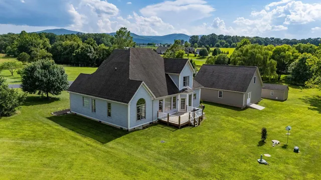 a aerial view of a house with garden plants and large trees