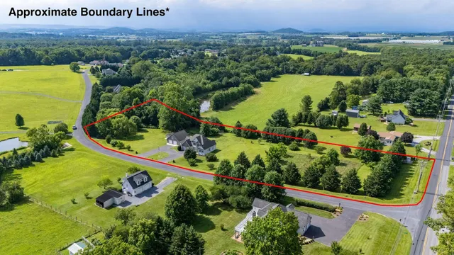 an aerial view of lake and residential houses with outdoor space