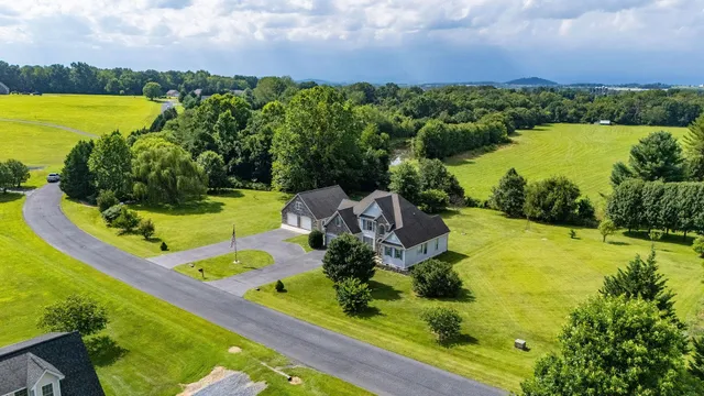 an aerial view of a houses with a lake view